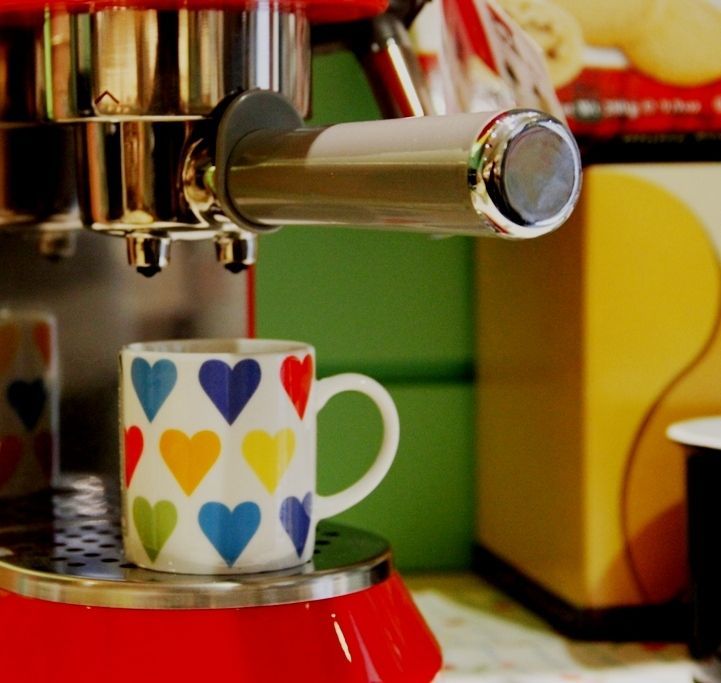 Cafetera espresso Smeg y taza de porcelana con corazones en INHALA Cafés y Tés, Granollers.