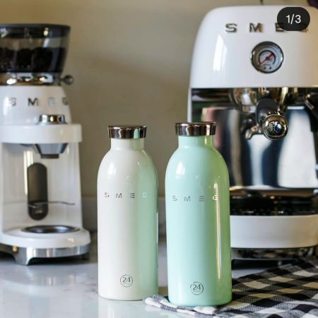 La botella térmica Clima de Smeg es el resultado de la colaboración entre Smeg y 24Bottles, combinando diseño icónico con funcionalidad. Y en ese color verde agua mint es preciosa, pero también la tenemos en color negro y en rojo pensando en regalo para San Valentín. Con un acabado liso y brillante y el logo en relieve, evoca el estilo de Smeg de los años 50, manteniendo las bebidas calientes o frías durante todo el día. Material seguro: Acero inoxidable 18/8 de calidad alimentaria 100% hermético, asegurando que quede perfectamente cerrada y no pierda líquido. Mantiene tus bebidas a la temperatura ideal por más tiempo: 24 h frío y 12 h calor. Pesa 300 grs. Mide 20,5 cm. x 7,3 cm. En INHALA Cafés y Tés somos punto de venta de pequeño electrodoméstico SMEG, artículos que te van a enamorar. Además de una cuidada selección de cafés, tés e infusiones, galletas, chocolates y muchos complementos para la mesa y cocina. Estamos en Portalet, 9 de Granollers, Barcelona. Y nuestra tienda Online siempre está abierta para tí.